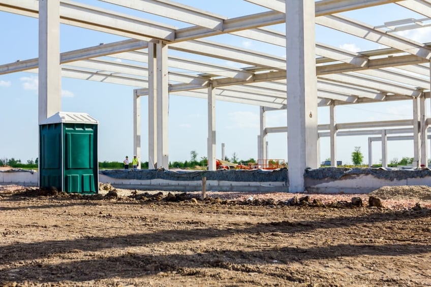 singular portable toilet on construction site