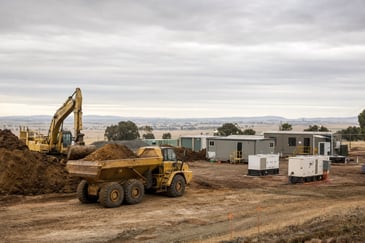 Regional industrial site near Ballarat with skid-mounted generators supplying temporary power to earthmoving and processing equipment.