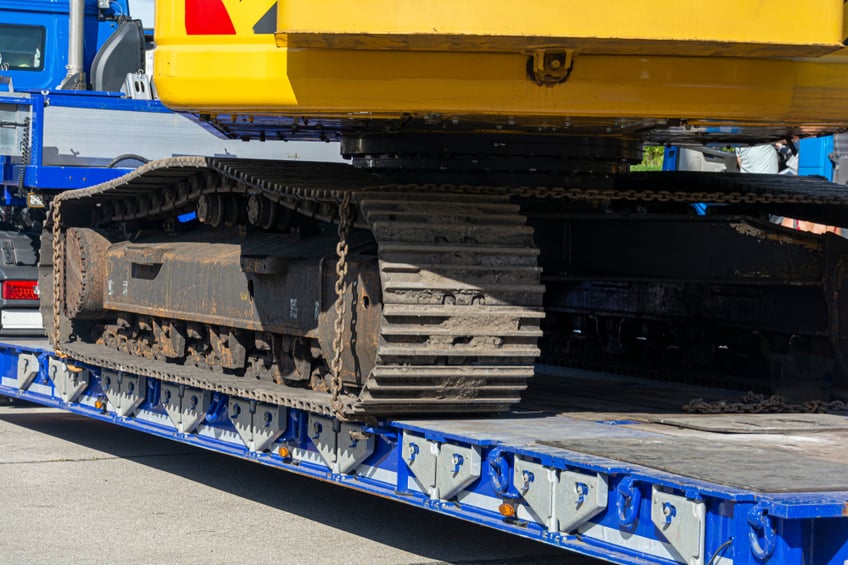 Low loader with excavator