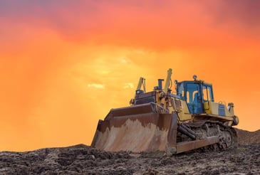 Dozer on construction site at sunset
